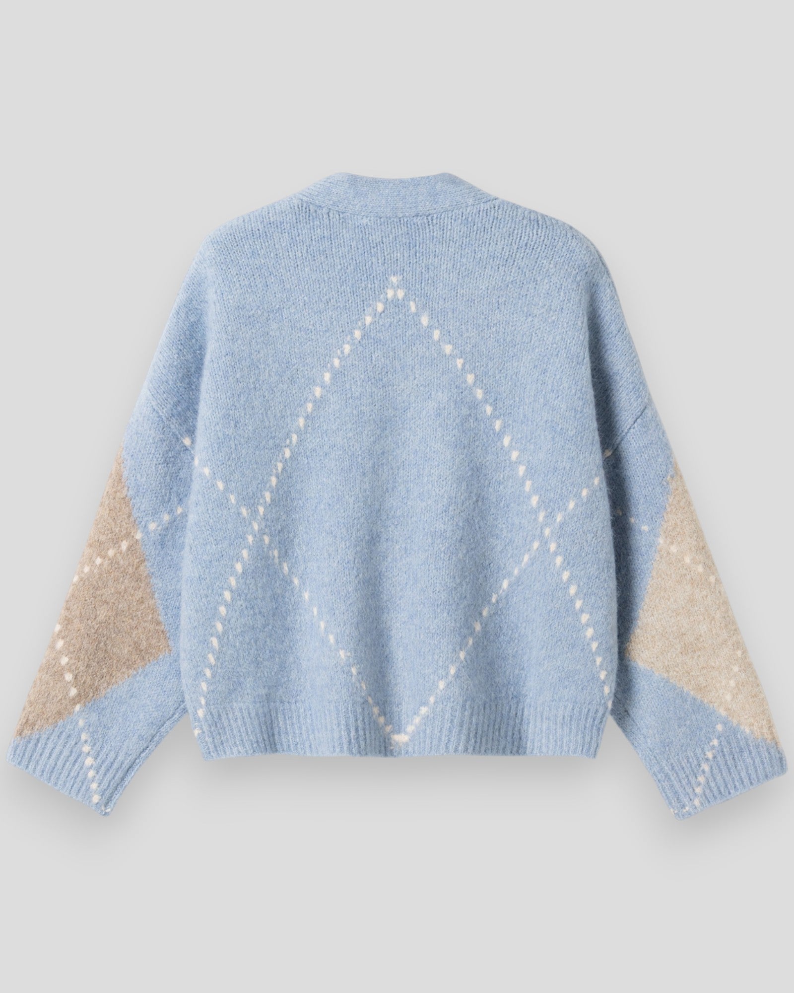 Dame strikket cardigan fra Noella i blå og lyseblå nuancer, vises på model med åben front og ribkant.