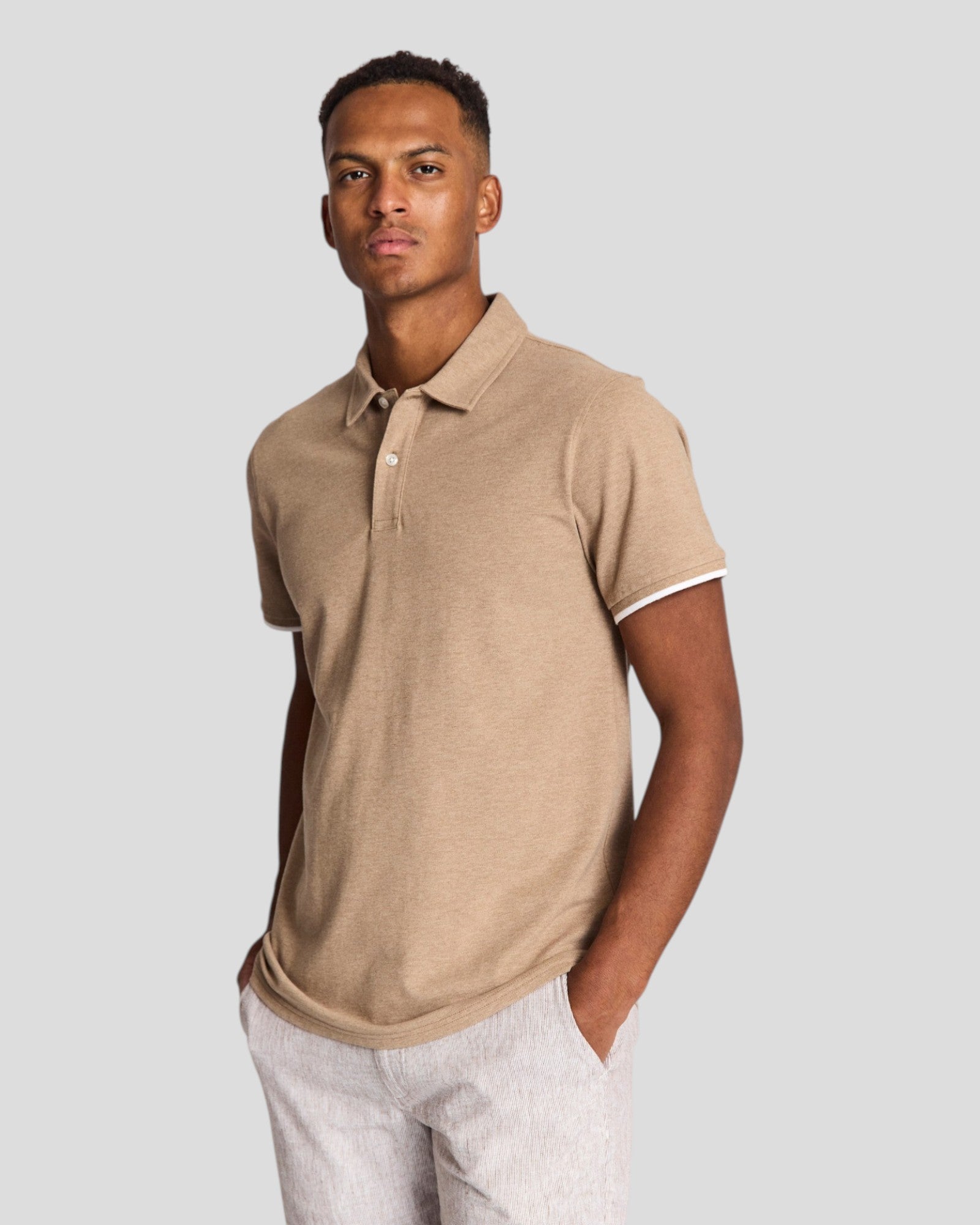 Bruun & Stengade Delos regular fit brown polo shirt displayed on a hanger, showing collar and textured fabric.