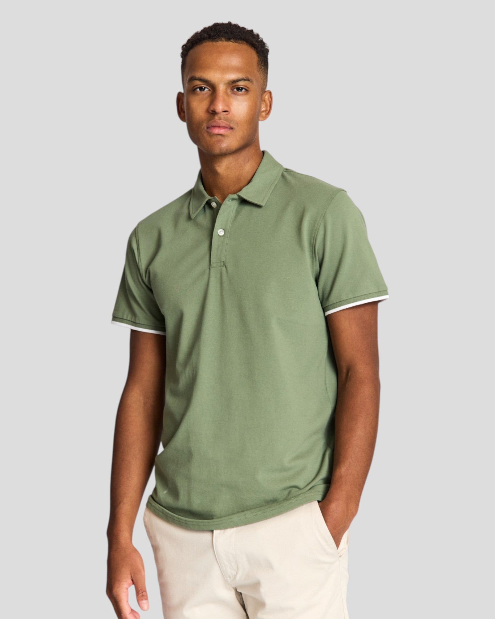 Green Delos regular fit polo shirt by Bruun & Stengade, shown laid flat with collar and short sleeves.
