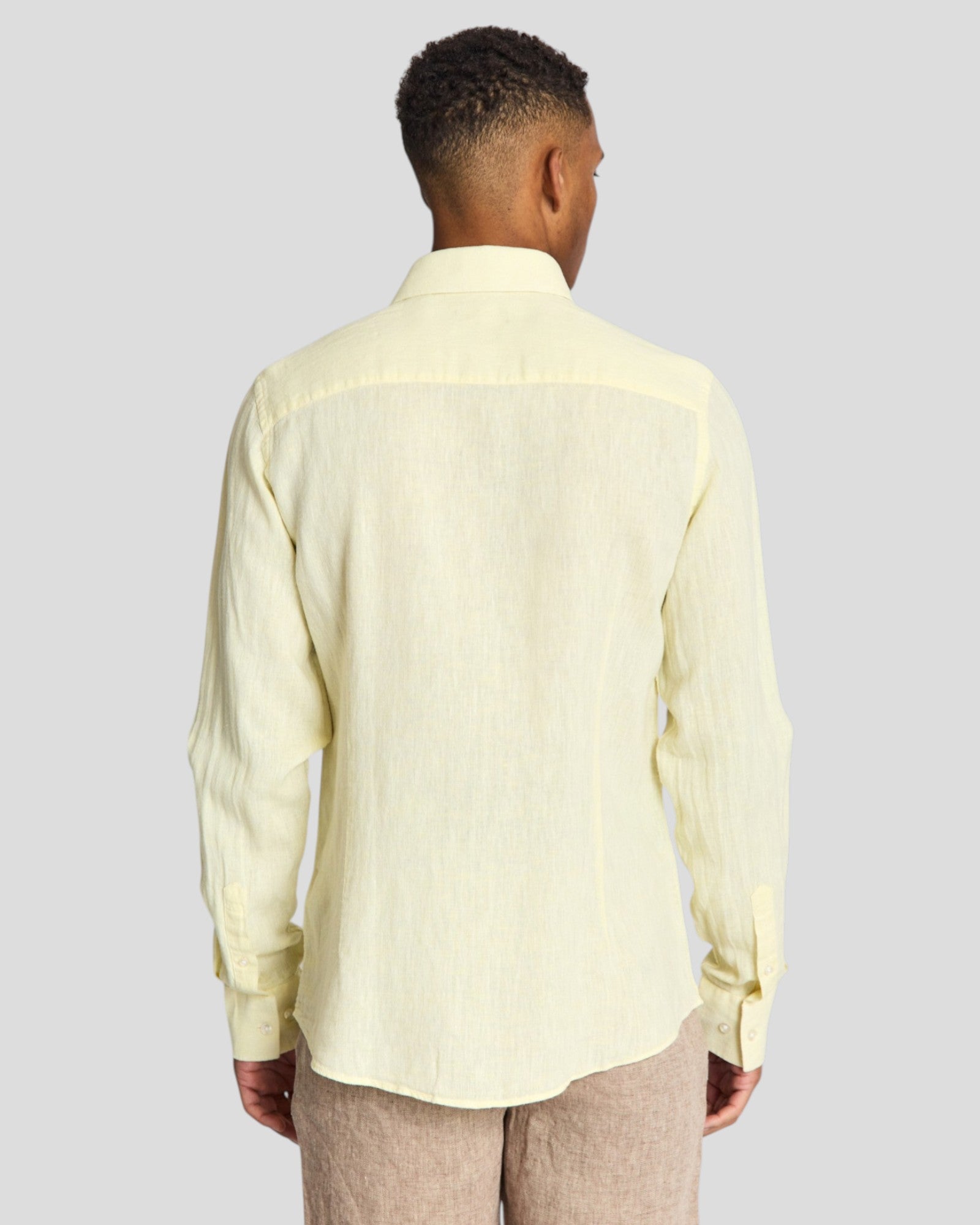 Yellow Tahaka Modern Fit Shirt by Bruun & Stengade displayed on a hanger, showcasing its casual, tailored design.