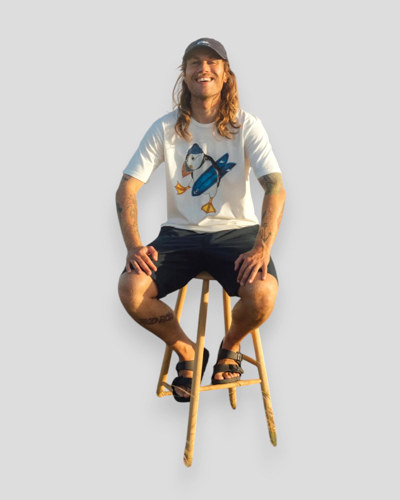 Hvid Surf’s Up t-shirt fra Lakor Soulwear med lunde-motiv og surfboard under armen