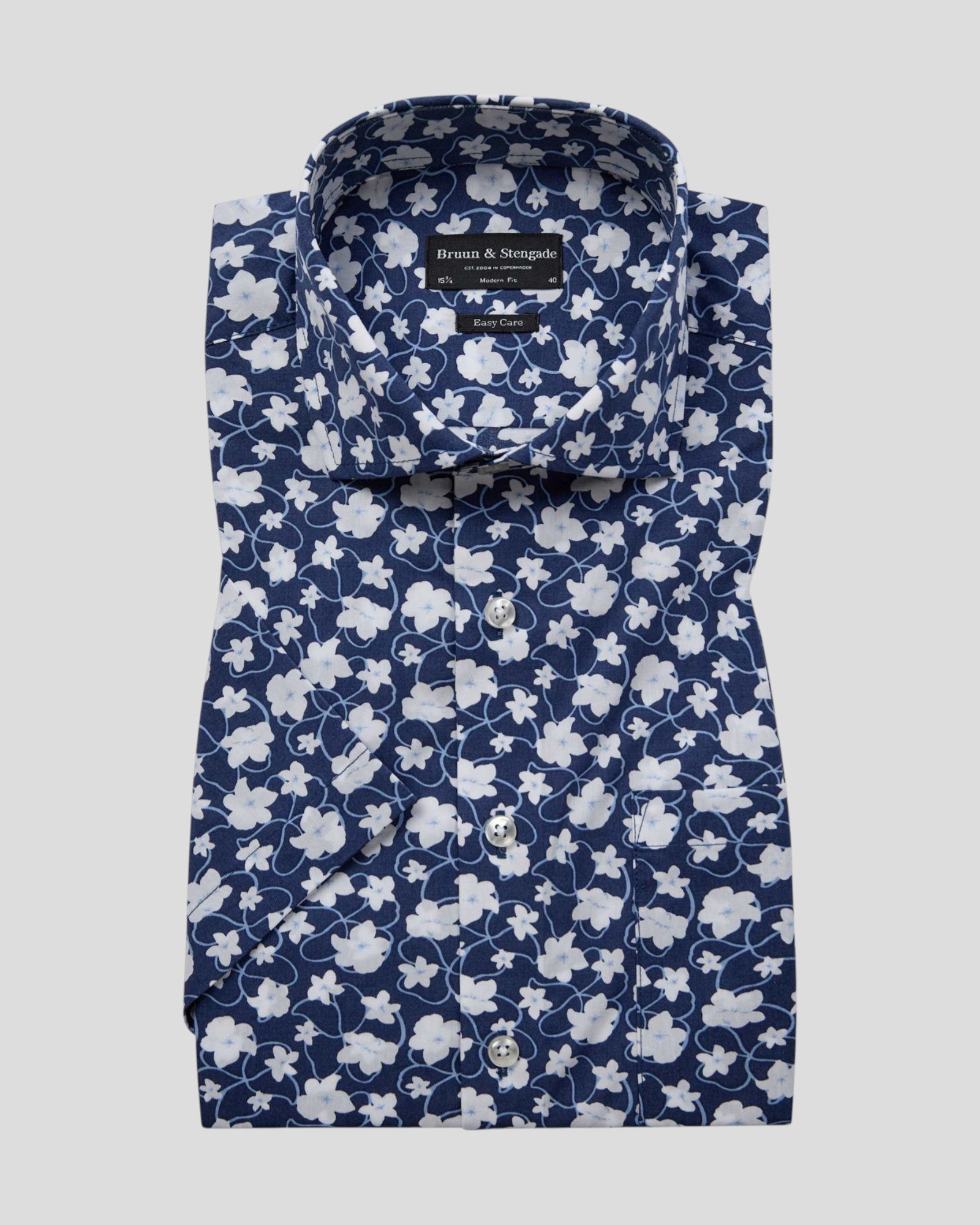 Dark blue Arpad modern fit shirt by Bruun & Stengade, displayed on a hanger with a close-up of fabric texture.