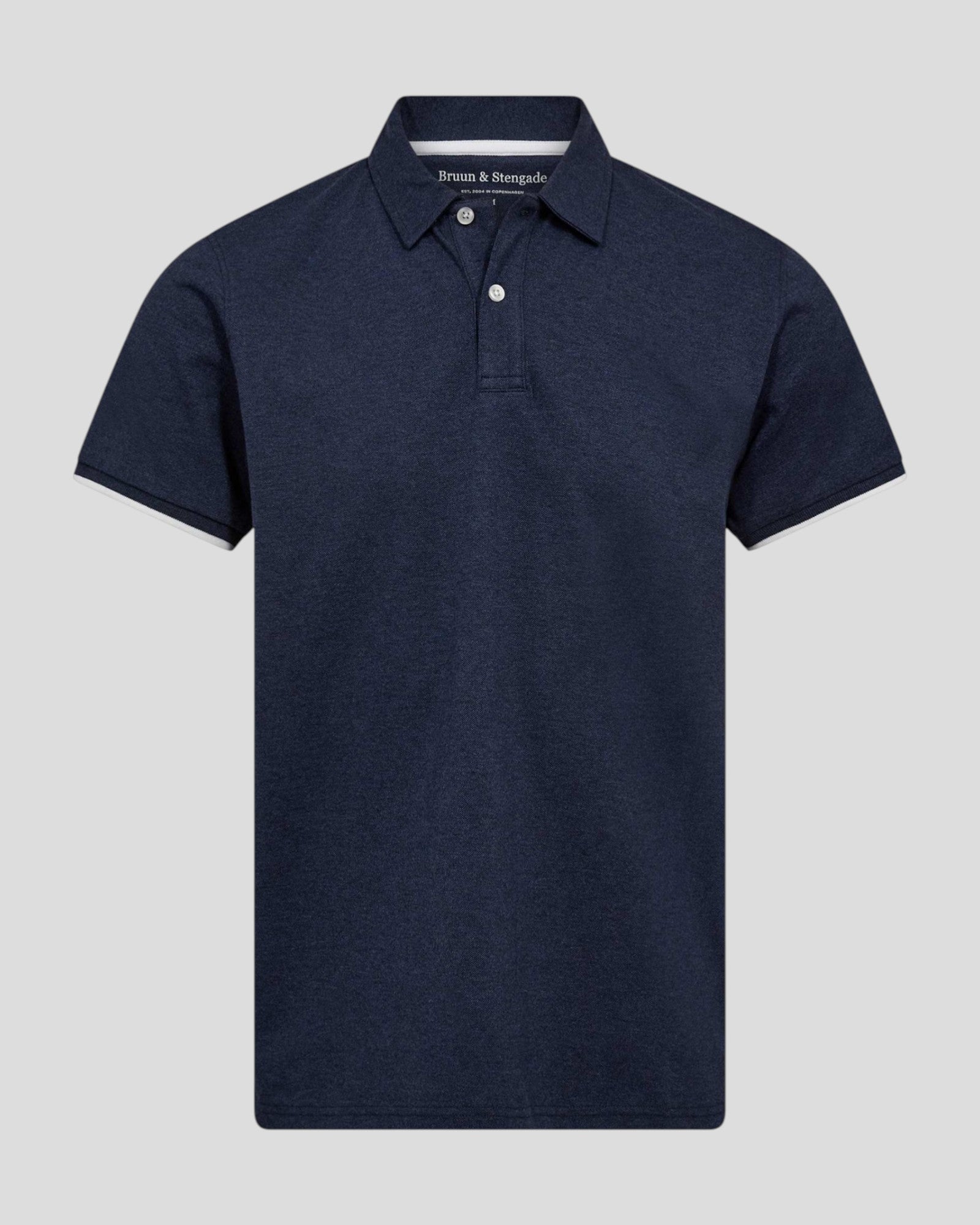 Navy Delos regular fit polo shirt by Bruun & Stengade, shown on a hanger with a close-up of the collar and fabric texture.