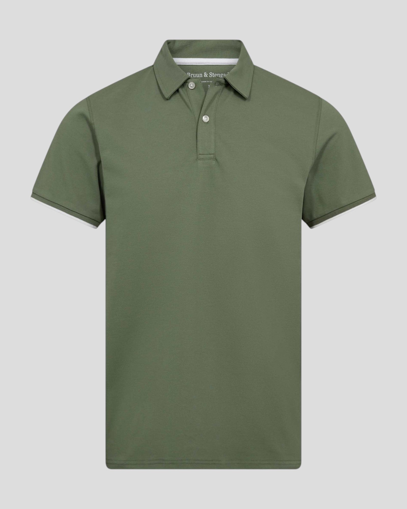 Green Bruun & Stengade Delos regular fit polo shirt displayed on a mannequin with a collar and short sleeves.