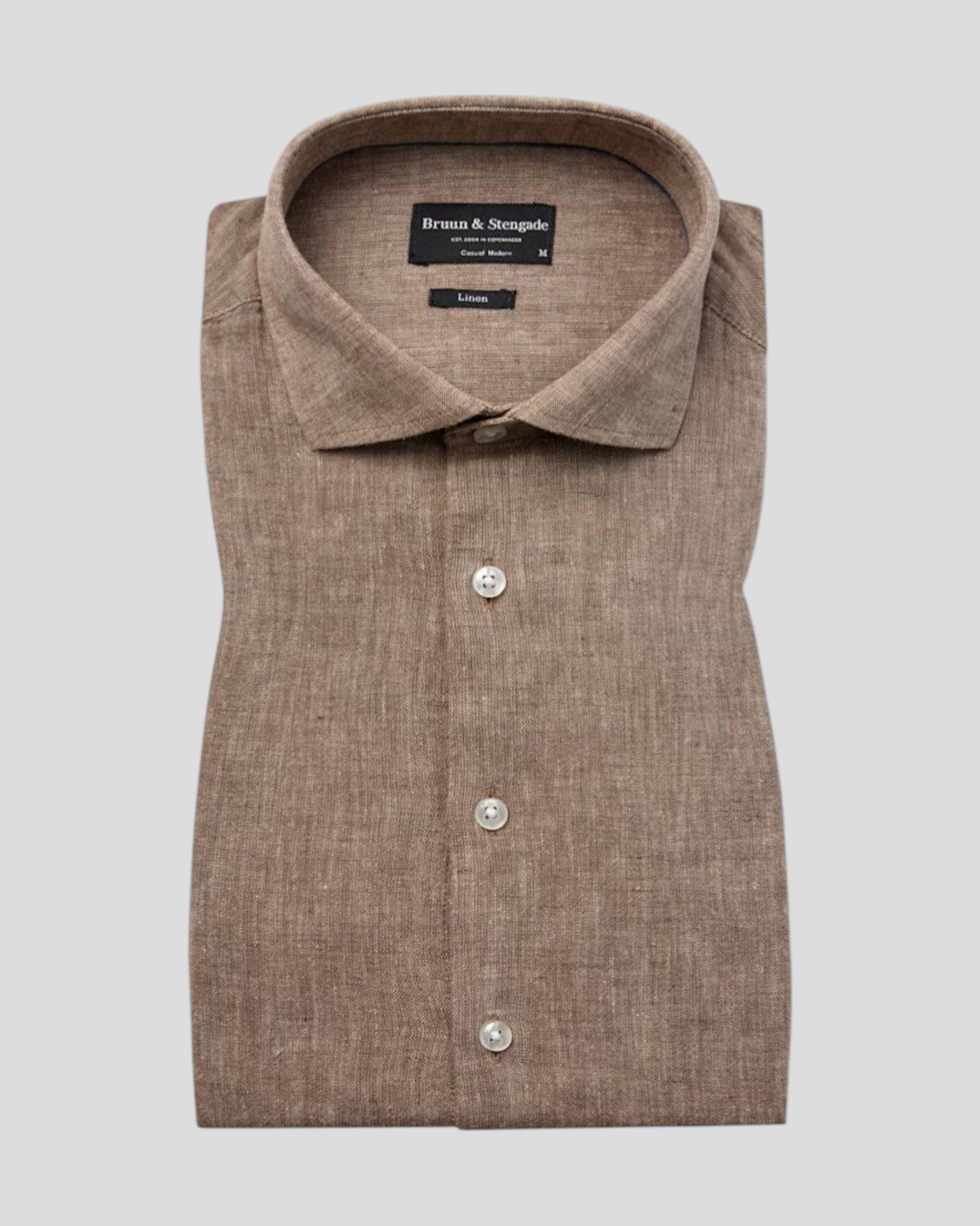 Bruun & Stengade Tahaka modern fit brown shirt, long-sleeve casual shirt with button closure, displayed on a hanger.