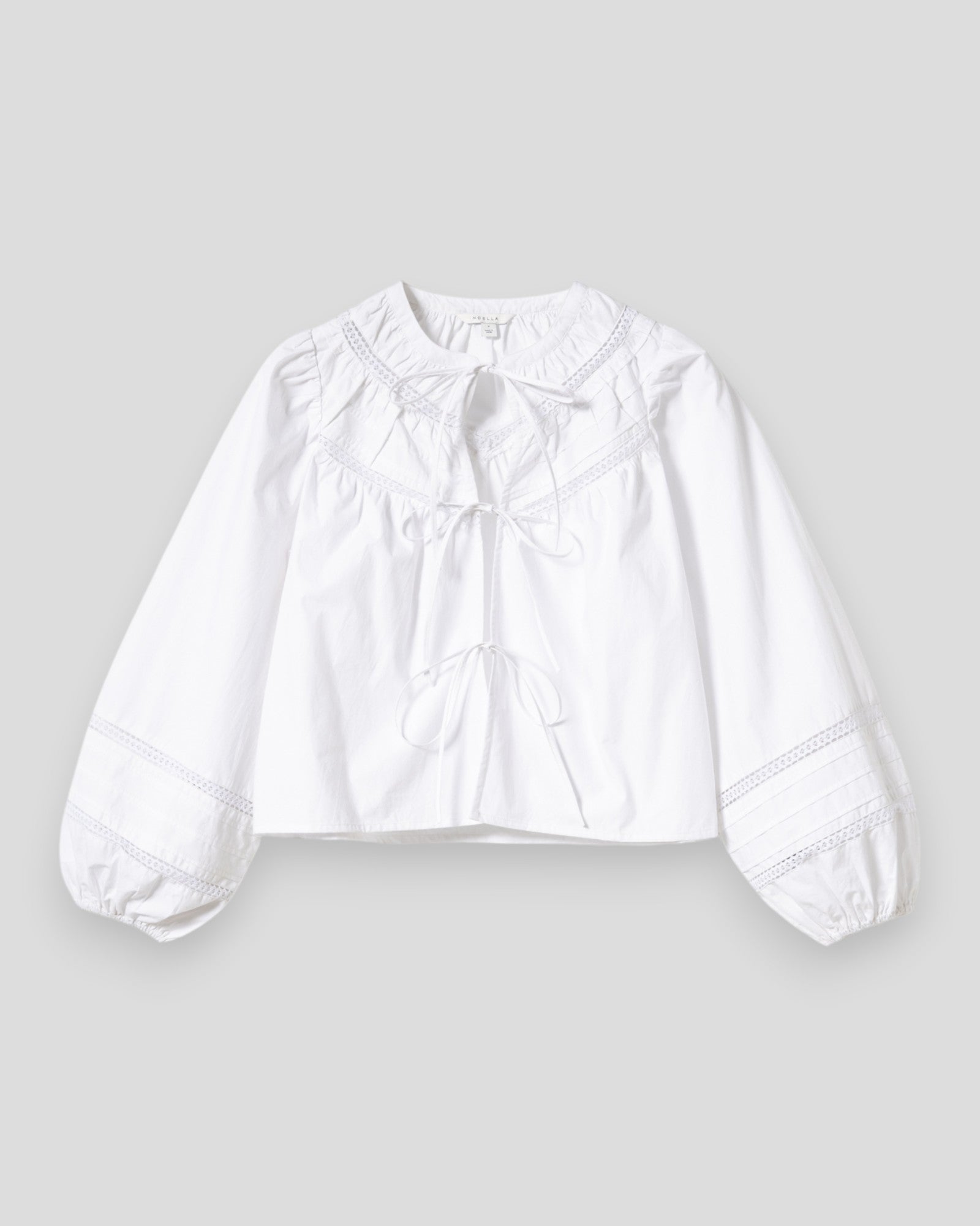 Noella N-Marceline white women's blouse with a relaxed fit and long sleeves, styled on a hanger against a plain background.