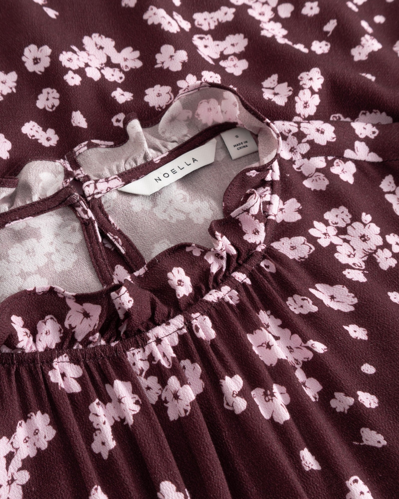 Noella N-Ruth Dress in Deja Burgundy Print featuring a stylish, flowy design with vibrant burgundy floral pattern.