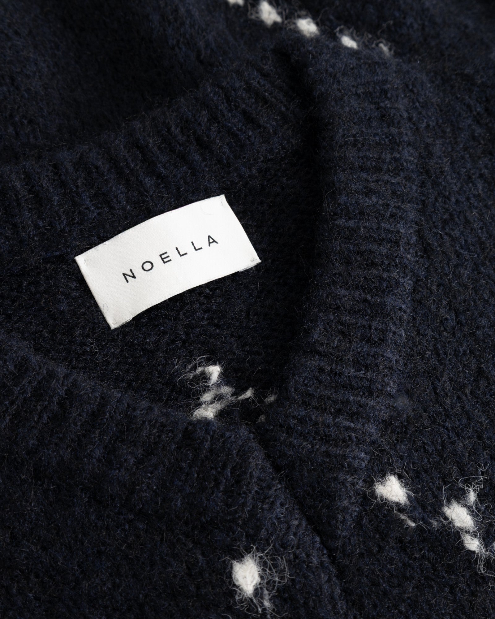 Noella women's navy knit sweater with a mixed navy pattern, featuring a soft, cozy knit fabric and a stylish, relaxed fit.