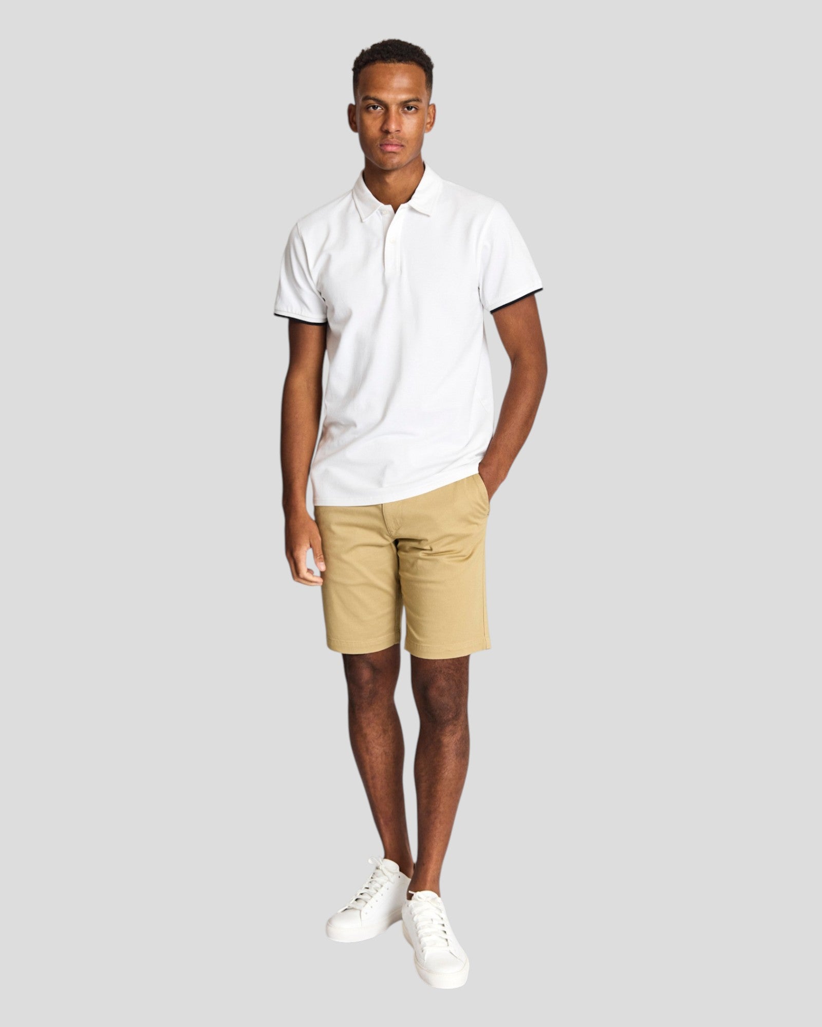 White Delos regular fit polo shirt by Bruun & Stengade, displayed flat with collar and buttons visible.