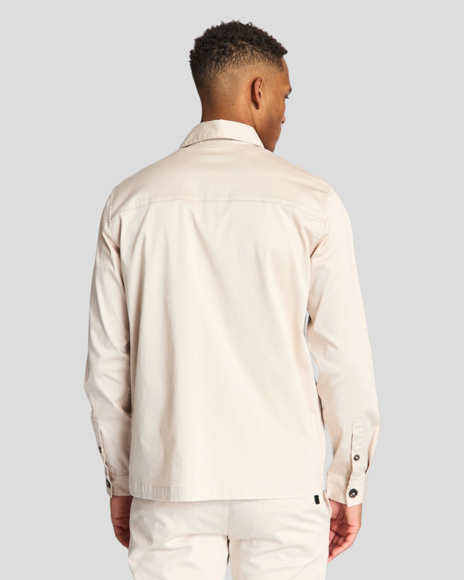 Bruun & Stengade Rocco regular fit overshirt in neutral fabric, shown in a casual style with a button-up front and collar.