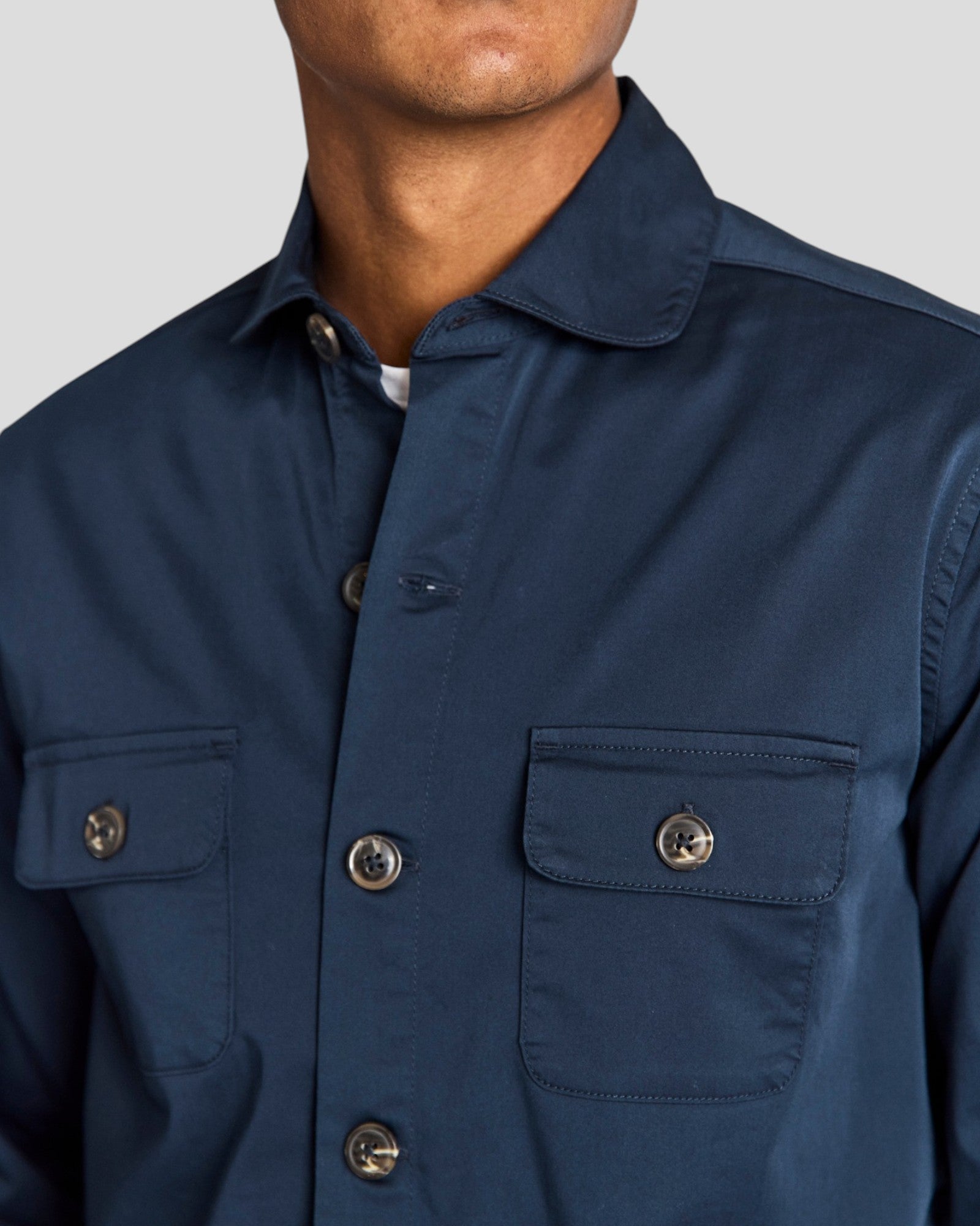 Navy Bruun & Stengade Rocco regular fit overshirt displayed on a hanger, showcasing the casual men's overshirt design and fabric details.