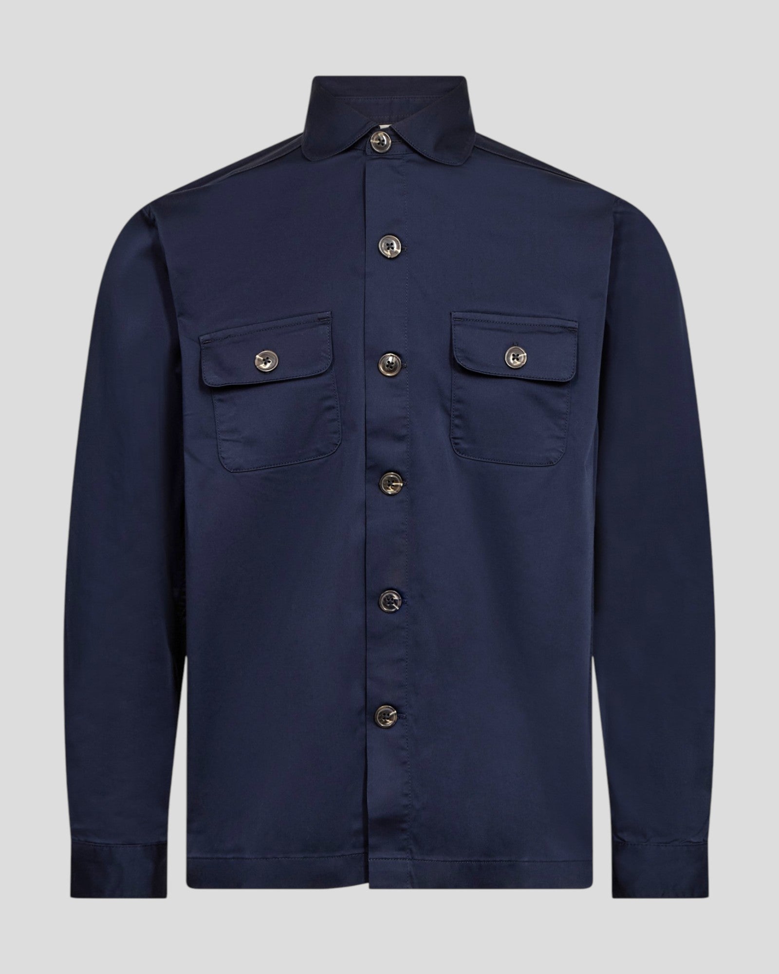 Navy Bruun & Stengade Rocco regular fit overshirt made of durable fabric, displayed on a hanger with button closure and chest pockets.