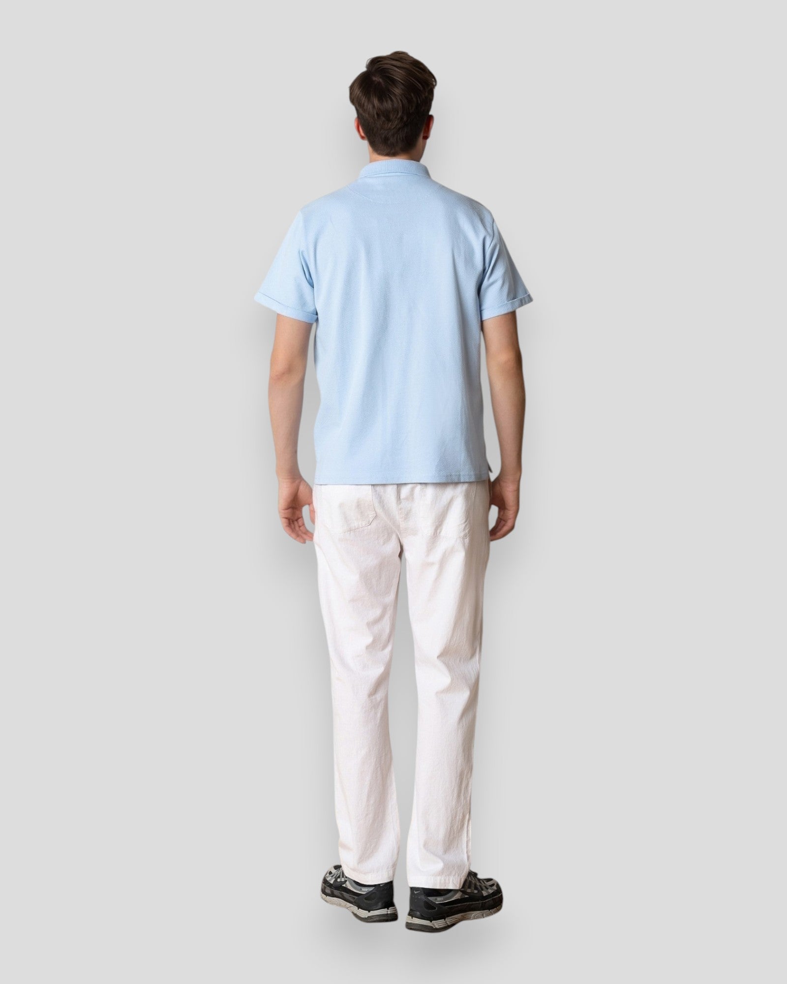 Light blue Silkeborg Stretch Polo by Clean Cut Copenhagen displayed on a hanger, showcasing its fit and fabric texture.