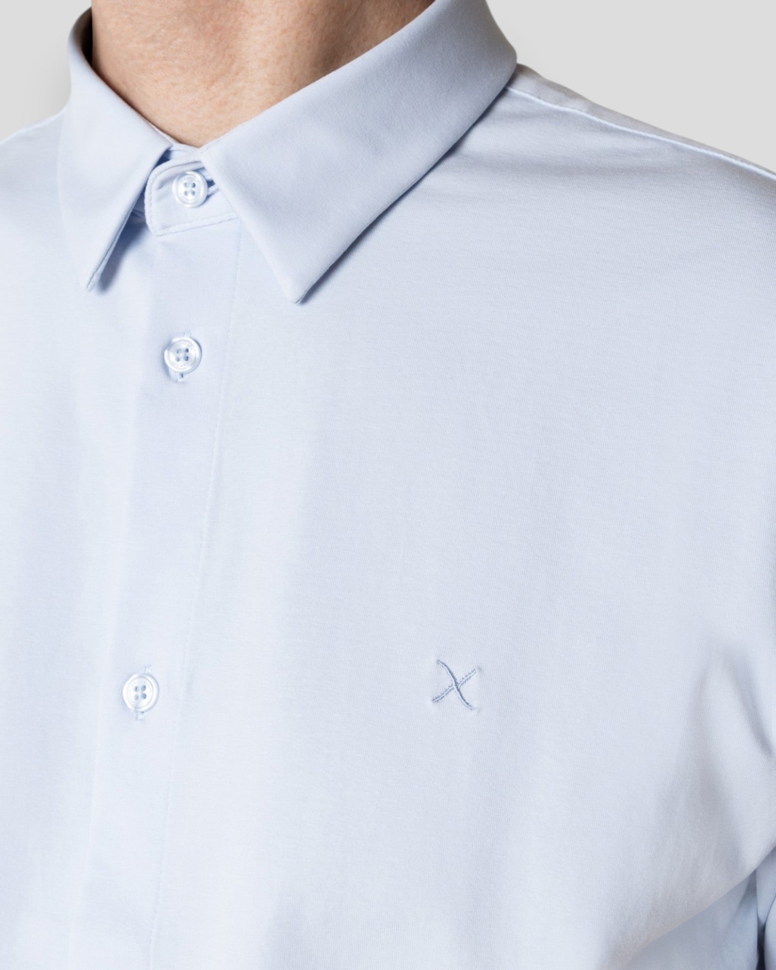 Light blue Clean Cut Copenhagen formal stretch shirt for men, short sleeve, neatly folded with visible collar and buttons.