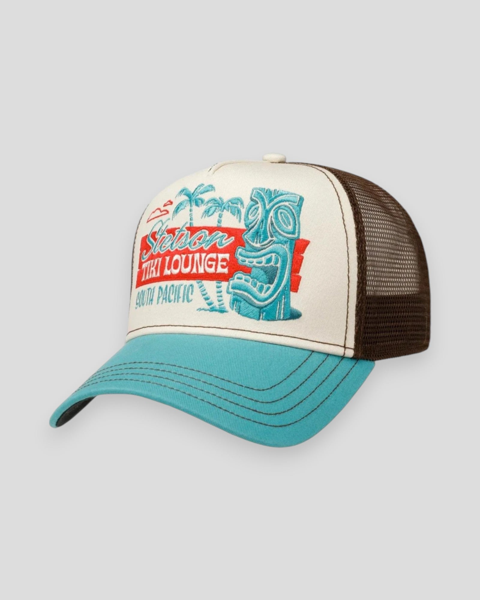 Stetson Tiki Lounge trucker cap i brun og blå med turquoise og sandfarvede detaljer, afslappet sommerstil.