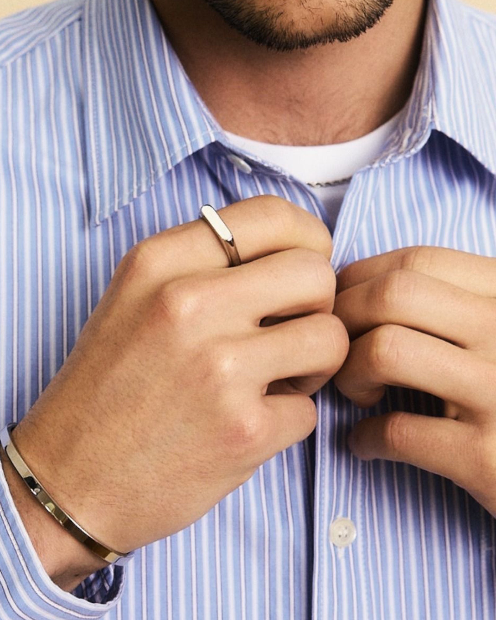Edblad Charlie Signet Ring in gold for men, featuring a sleek steel band and classic design, displayed on a neutral background.